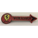 A painted cast iron wall hanging Ferrari Workshop arrow.