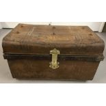 A Victorian 2 handled tin trunk with studded top and brass catch and lock.