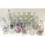 A box of 24 vintage advertising milk bottles.