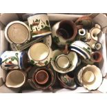 A box of assorted Torquay ware pottery items to include: butter dishes, jugs, pin trays and egg cups