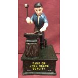 A painted cast iron John Deere mechanical money bank, with push button action.