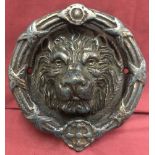 A large cast iron Lions head door knocker.