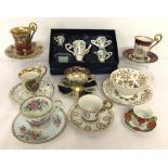 A collection of assorted ceramic cups and saucers together with a boxed miniature tea set.