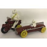 2 painted cast iron Michelin figures; a racing car and a motorcycle with removable figure.