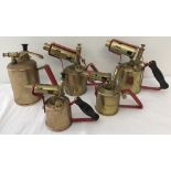 4 vintage brass blow lamps together with a vintage brass sprayer.