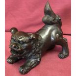 A hollow bronze figure of a Chinese Foo Dog.