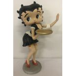 A painted cast iron figure of Betty Boop dressed as a waitress.