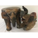 A vintage carved wood elephant stool/table together with an elephant rocker.