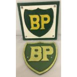 2 cast iron BP wall plaques, painted green, white and yellow.
