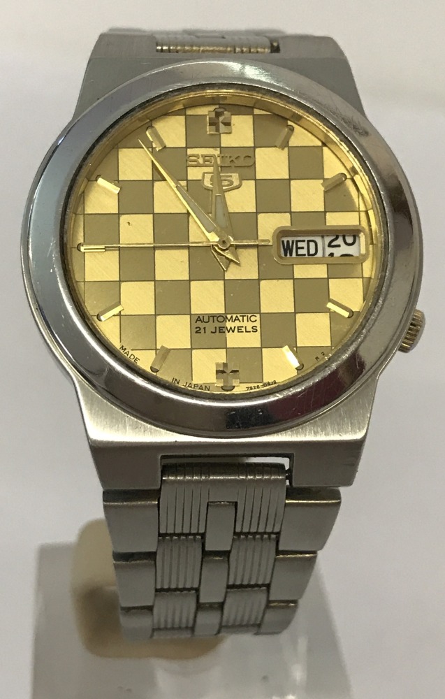 A boxed vintage Seiko Automatic 5 wrist watch with gold tone chequered face.