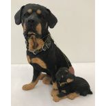 A Country Artists heavy resin ornament of a Rottweiler dog and puppy.