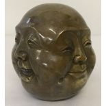 A brass paperweight of a 4 faced Buddha, signed to underside.