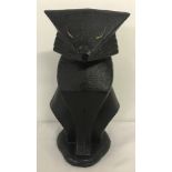 A heavy cast iron door stop in the shape of an Art Deco style cat.