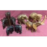 A collection of wooden elephant figures to include bookends.