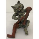 After Bergmann - a cold painted bronze figure of a cat, cleaning boots.