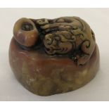 An Oriental soapstone seal with carved dragon detail to top and Chinese symbols to underside.