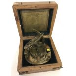 A wooden cased brass sundial and compass, marked J.H.Steward Ltd, Strand, London.
