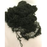 A quantity of 28 British modern dark green helmet nets.