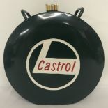 A round shaped Castrol fuel can painted green with white logo and red writing.