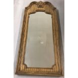 A large framed decorative wall mirror in a neo-classical style.