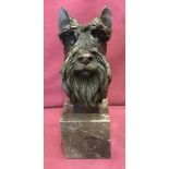 A bronze figurine of a Scottish Terrier head, mounted on a square marble base.