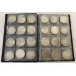 A folder containing 72 assorted white metal coins from around the world.