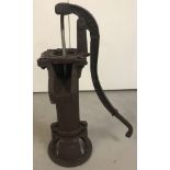A cast iron ornamental garden pump.