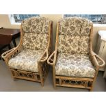 2 modern cane conservatory chairs with floral decorated cushions.