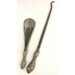 An antique silver handled shoe horn together with a silver handles buttonhook.