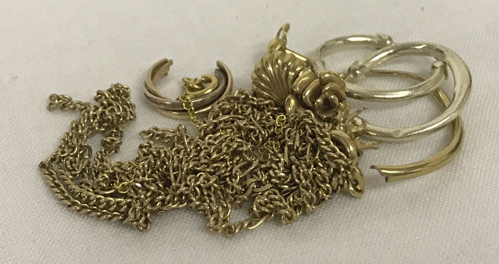A small quantity of scrap 9ct gold. To include broken chains and single earrings.