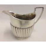 A late Victorian silver cream jug with classic design detail.