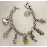 A Links Of London silver charm bracelet with t bar fixing and 8 charms.