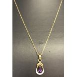 A 9ct gold decorative drop necklace set with amethyst and diamonds.