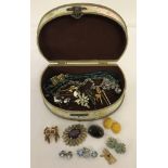 A vintage style jewellery box containing a small quantity of vintage costume jewellery.