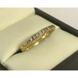 An 18ct gold channel set diamond eternity ring.