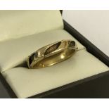 An 18ct gold decorative band ring with inscription to inside of band.