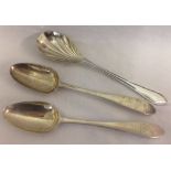 A pair of sterling silver serving spoons with arm and dagger monogram to handles.