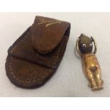 A WWI Fumsup 9ct gold and wood, good luck mascot charm, complete with leather case.