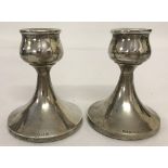 A pair of silver candlesticks hallmarked Birmingham 1958 and marked for William Adams Ltd.