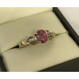 A 9ct gold ladies dress ring set with central oval cut pink tourmaline.