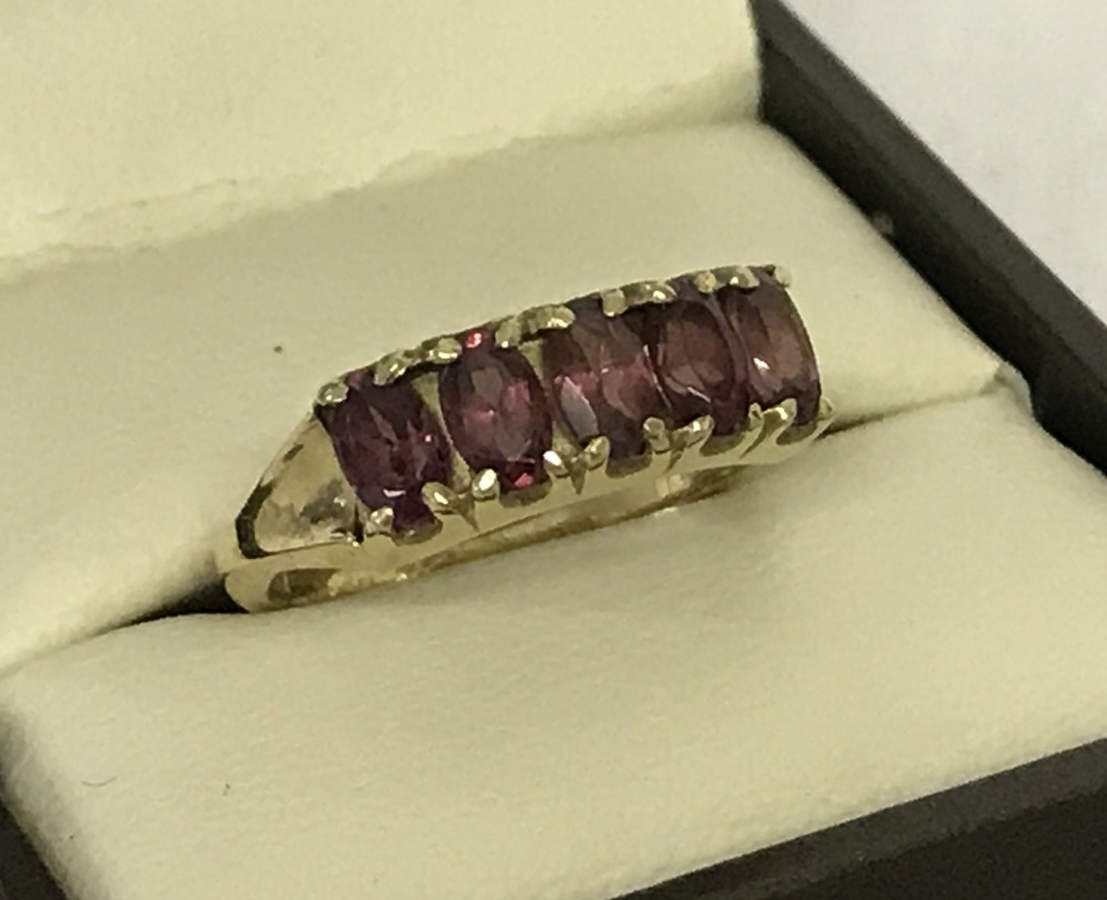 A 9ct gold ladies dress ring set with 5 oval cut rhodonite garnets.