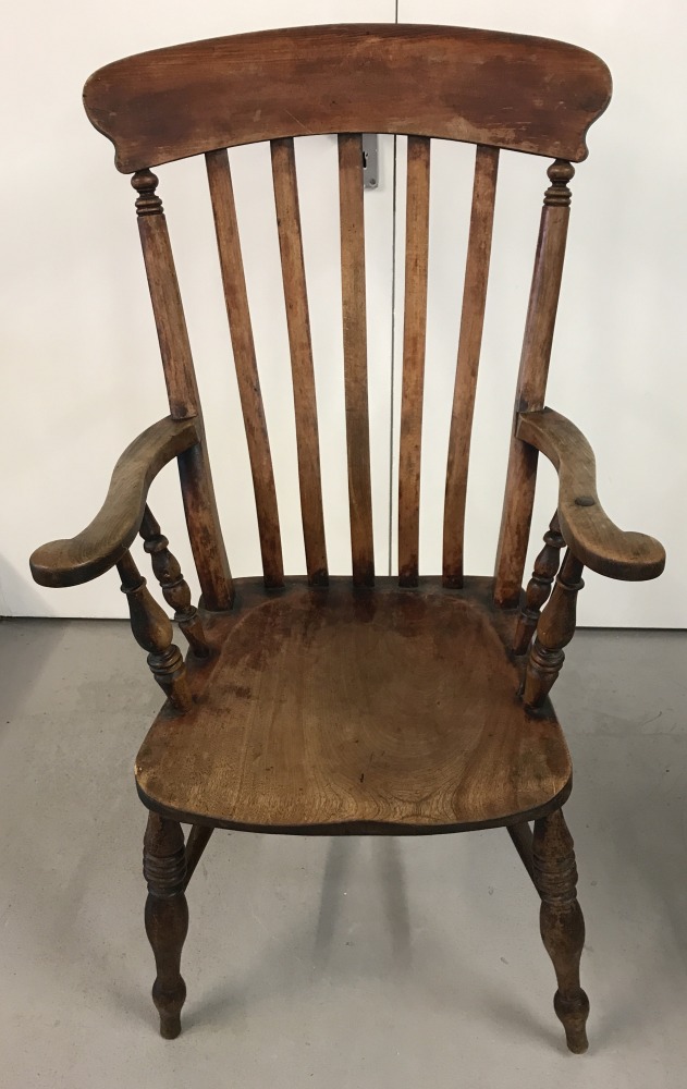 An antique beeck wood slat backed Grandfather chair with turned detail to legs and arm supports.