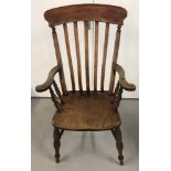 An antique beeck wood slat backed Grandfather chair with turned detail to legs and arm supports.