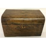 An antique walnut veneer, dome topped tea caddy with inlay decoration to lid and key hole.