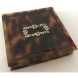 A vintage tortoiseshell effect Art Deco powder compact set with small clear stones.