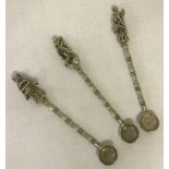 3 Chinese white metal spoons with deity figures to handles and bamboo design to stems.