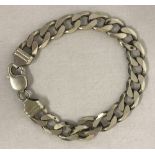 A heavy curb chain silver bracelet with lobster clasp.
