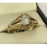 An 18ct gold gypsy style dress ring set with cental diamond. Size P½.