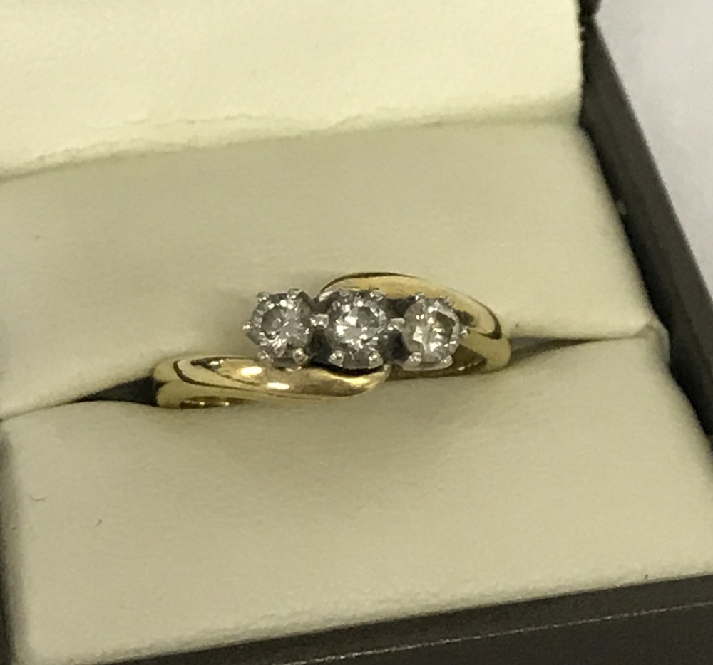 A 18ct gold, diamond set, twist design, trilogy past, present and future ring.