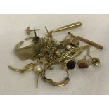 A small quantity of scrap 9ct gold. To include stone set single earrings and broken chains.